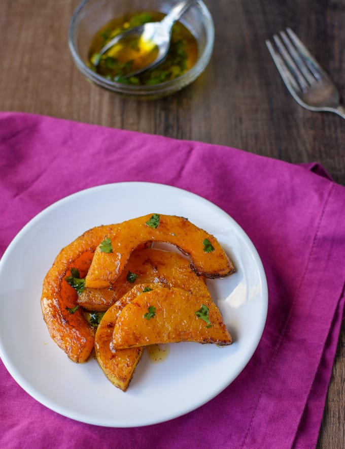 Slices of roasted butternut squash on a white plate