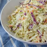 A large bowl of healthy coleslaw sitting on a towel.